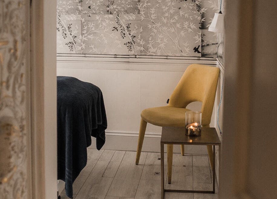 Elegant Treatment Rooms in Hastings, England, GB featuring a cozy setup with a candlelit table and chair.