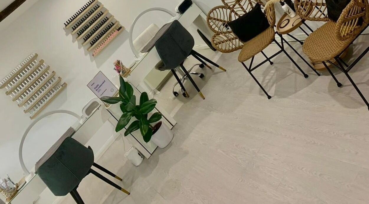 Elegant nail salon at Phoenix Beauty in Maidstone, England, GB, featuring stylish chairs and nail polish displays.