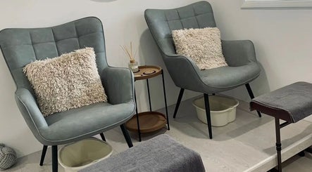 Relaxing seating area for pedicures at Phoenix Beauty, Maidstone, England, GB. Plush chairs and soft lighting.