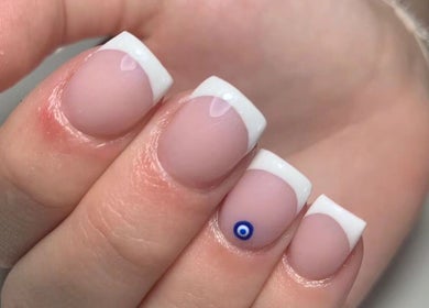 Close-up of elegant French manicure with blue accent by Phoenix Beauty, Maidstone, England, GB.