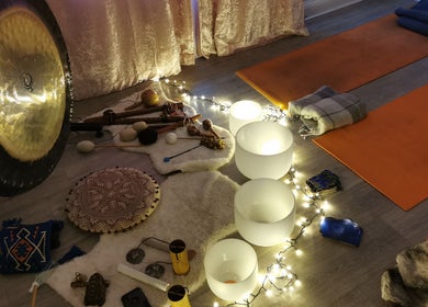 Tranquil meditation setup at Vanity, Leicester, England, GB featuring gongs, singing bowls, and candles.