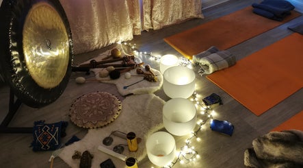Tranquil meditation setup at Vanity, Leicester, England, GB featuring gongs, singing bowls, and candles.
