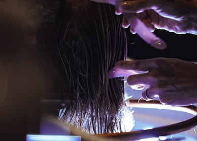 Close-up of stylist washing hair at Vanity, Leicester, England, GB, highlighting professional care services.