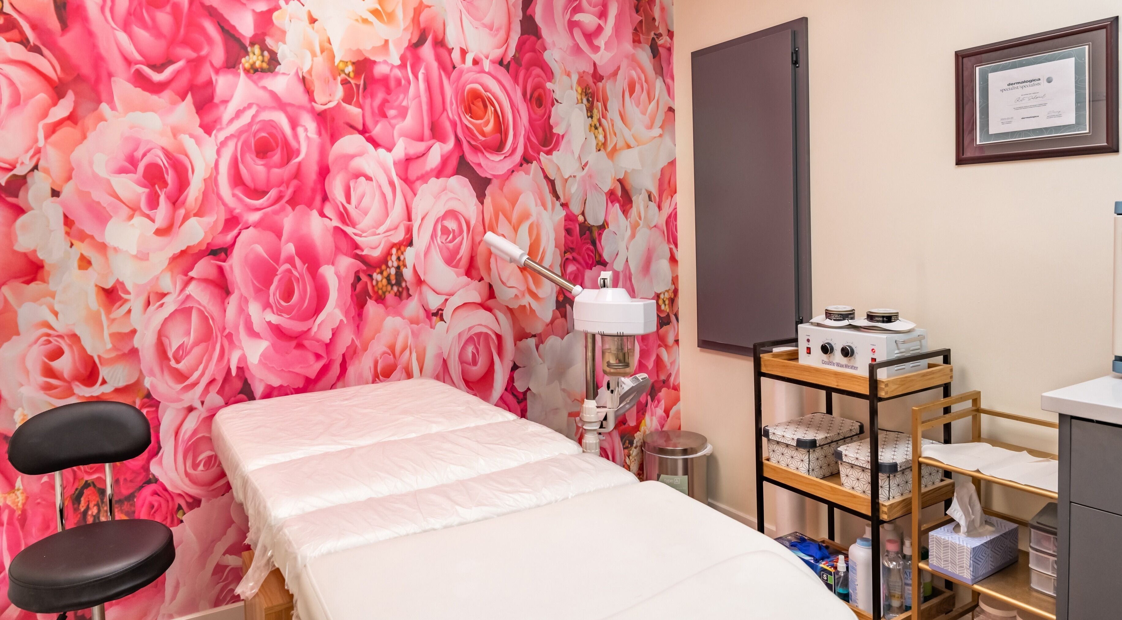 Namaste Beauty massage room with pink floral wall, located at Maple Ridge #330, British Columbia, CA.