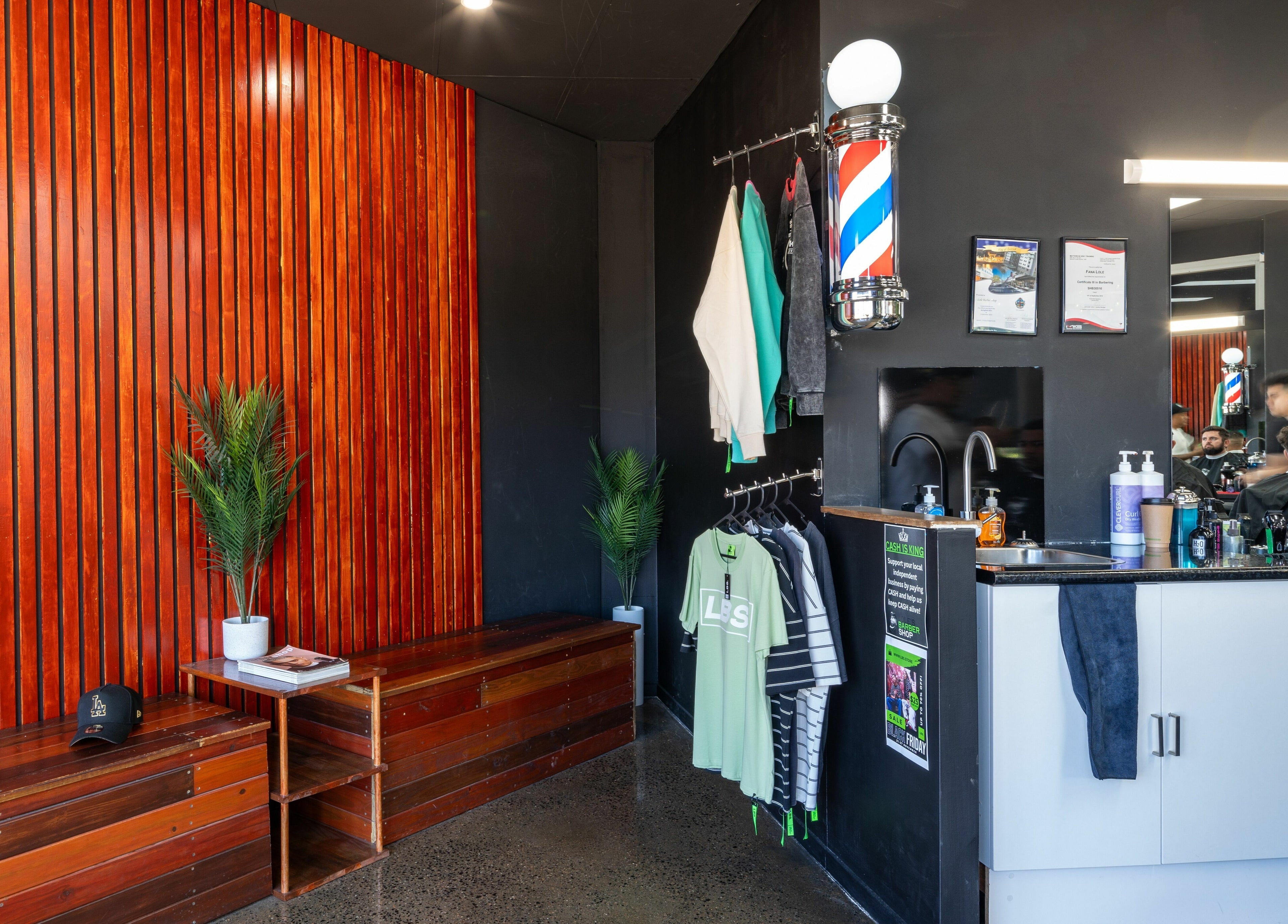 Interior of Lole's Barber Shop - Commercial Drive, Springfield, Queensland, AU with modern decor and grooming station.
