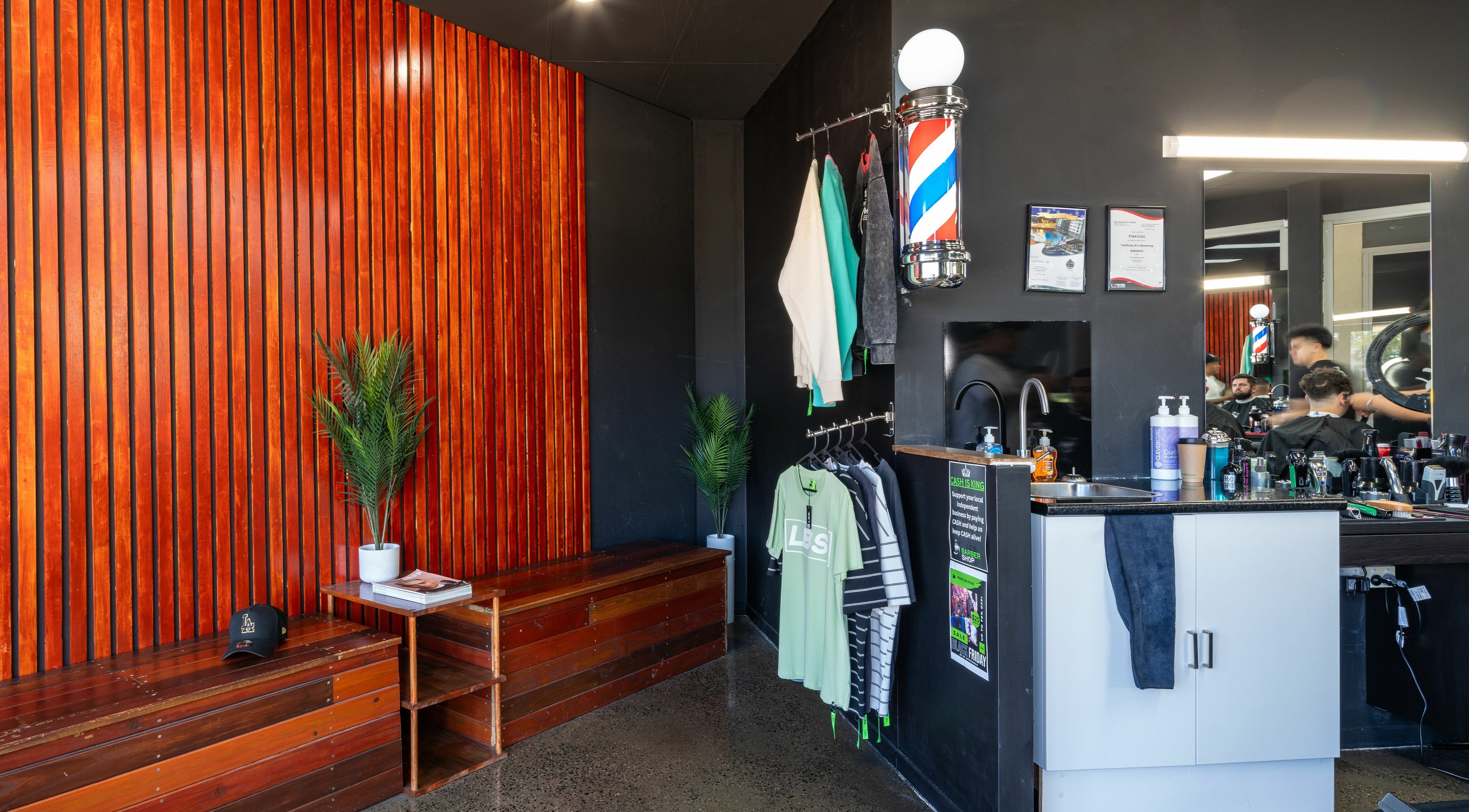 Interior of Lole's Barber Shop - Commercial Drive, Springfield, Queensland, AU with modern decor and grooming station.