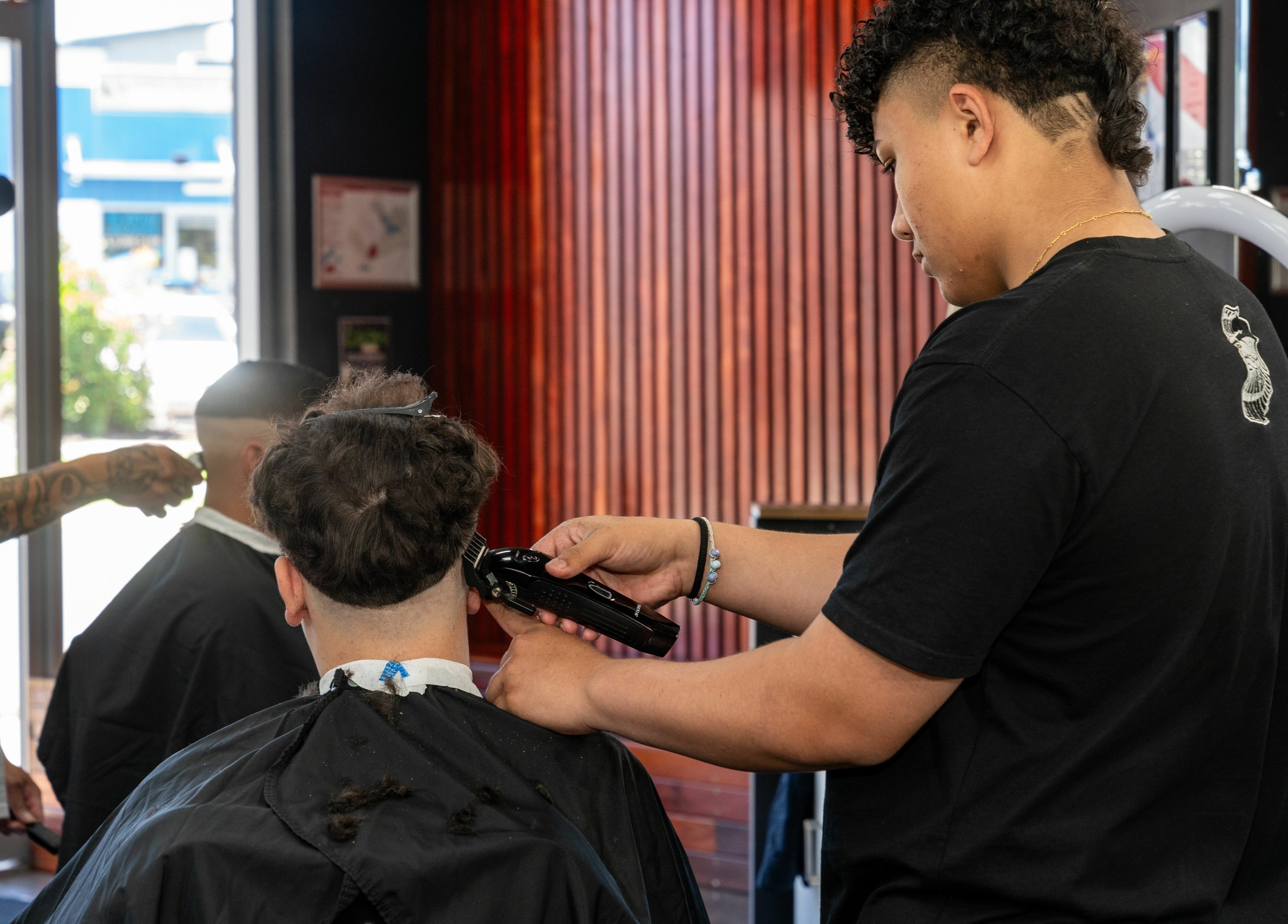 Stylists at work in Lole's Barber Shop - Commercial Drive, Springfield, Queensland, AU.