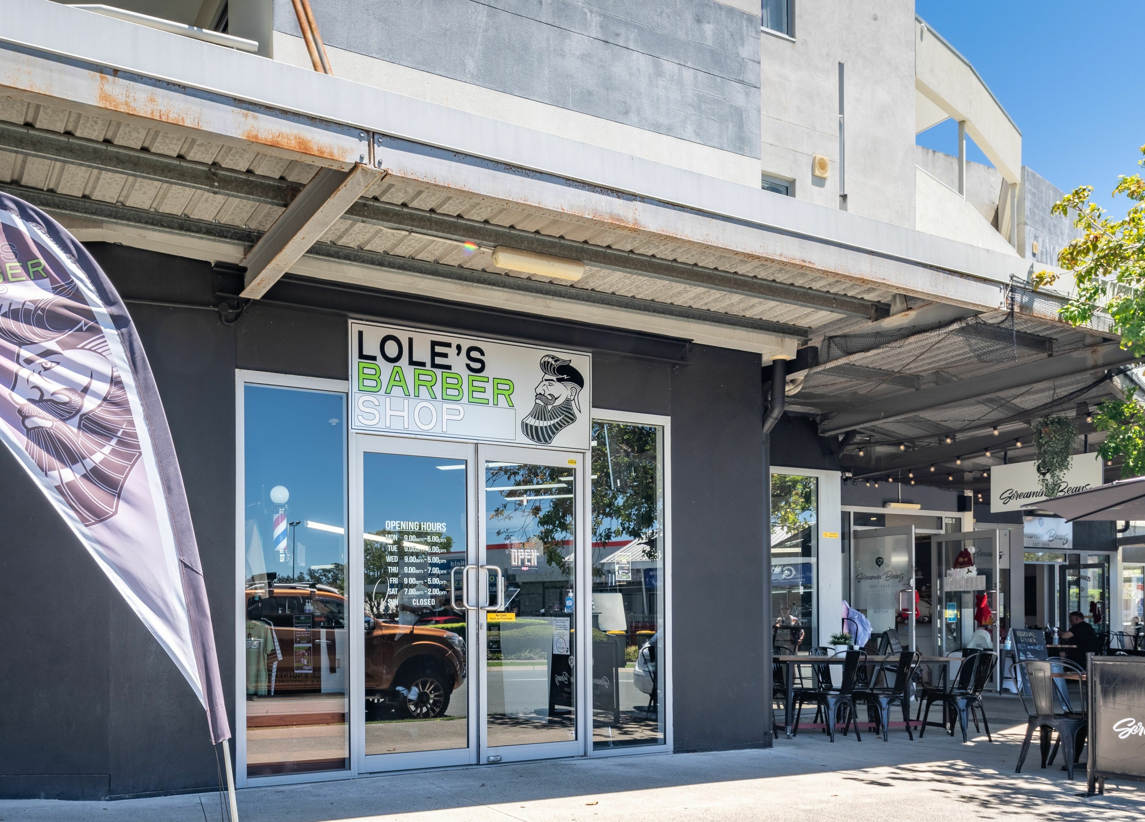 Lole's Barber Shop - Commercial Drive in Springfield, Queensland, AU with sleek modern storefront and vibrant signage.