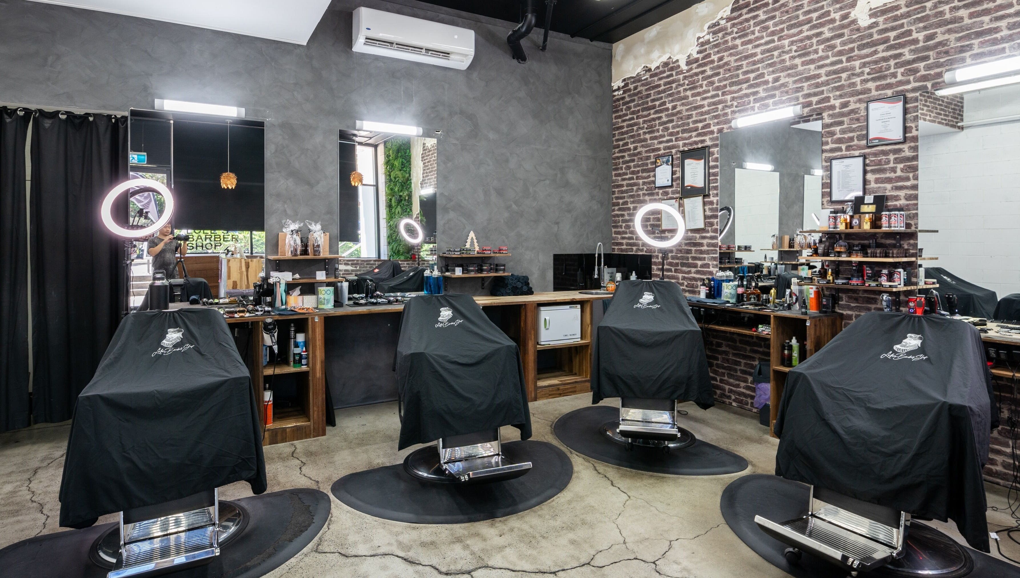 Interior of Lole's Barber Shop - Ian Keilar Drive, Springfield Central, QLD, AU showcasing elegant barber chairs.