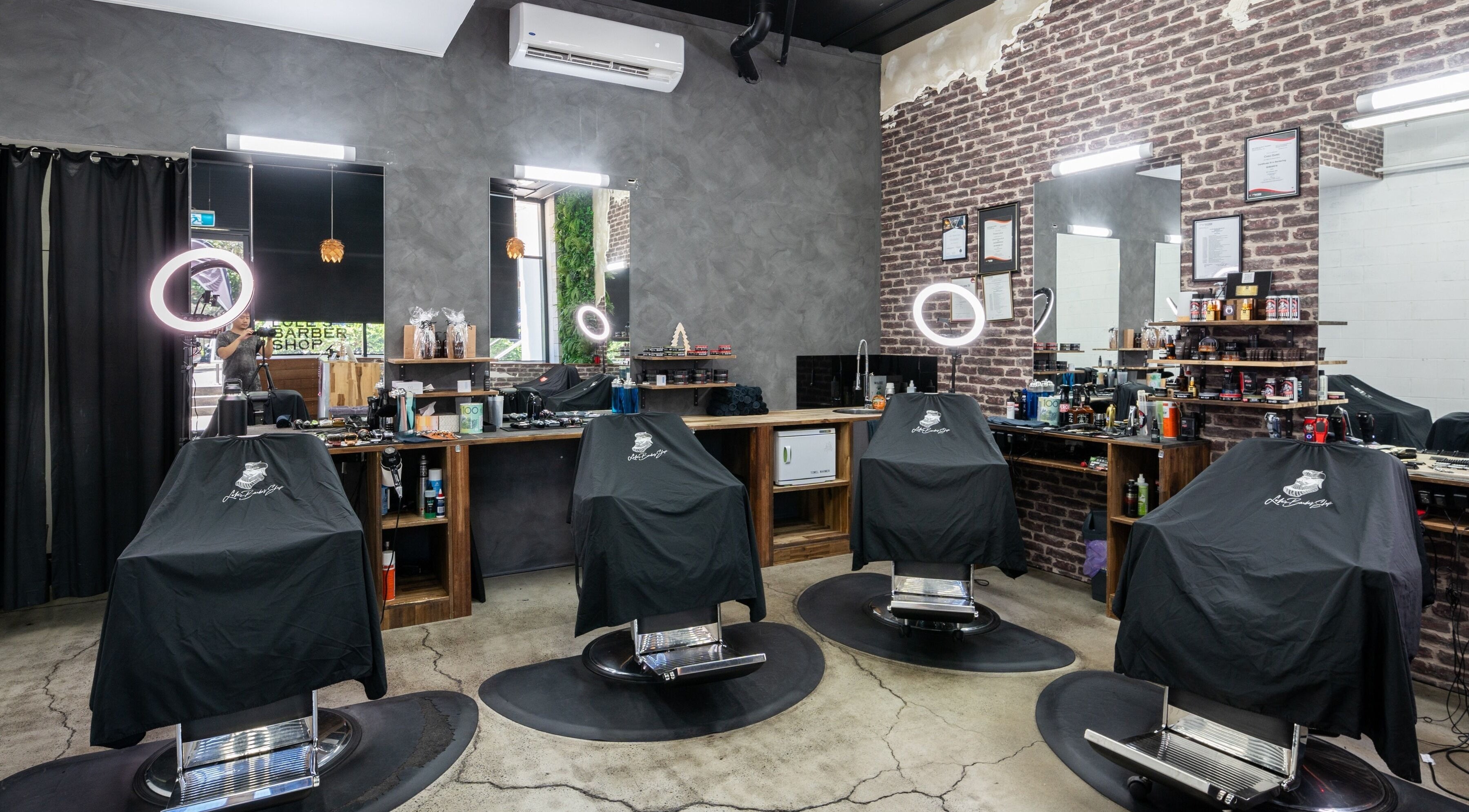 Interior of Lole's Barber Shop - Ian Keilar Drive, Springfield Central, QLD, AU showcasing elegant barber chairs.