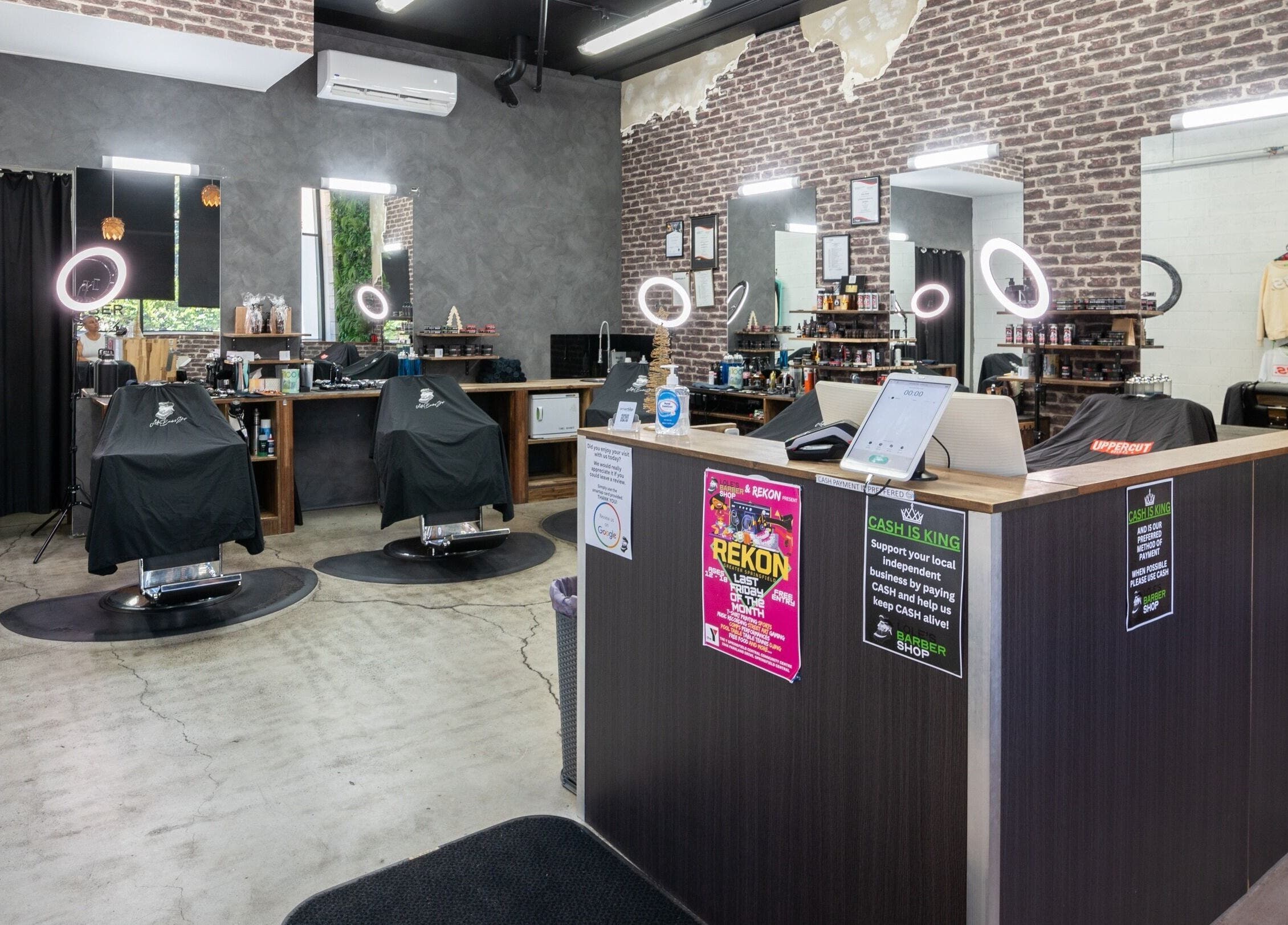 Chic interior of Lole's Barber Shop - Ian Keilar Drive, Springfield Central, QLD, AU, showcasing barber chairs and mirrors.