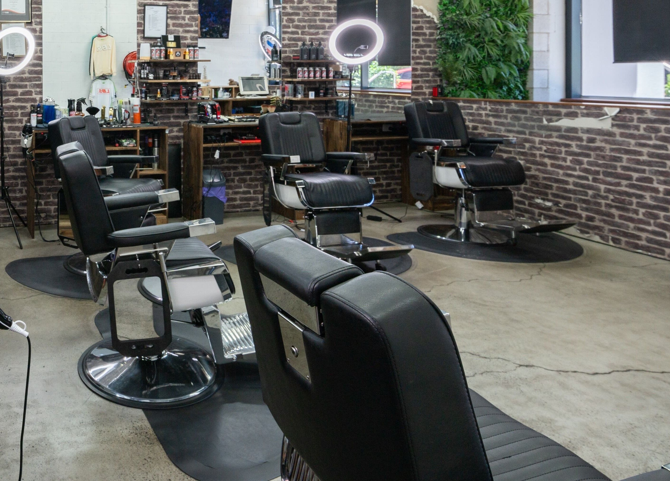 Modern interior of Lole's Barber Shop - Ian Keilar Drive, Springfield Central, QLD, AU with stylish black chairs.