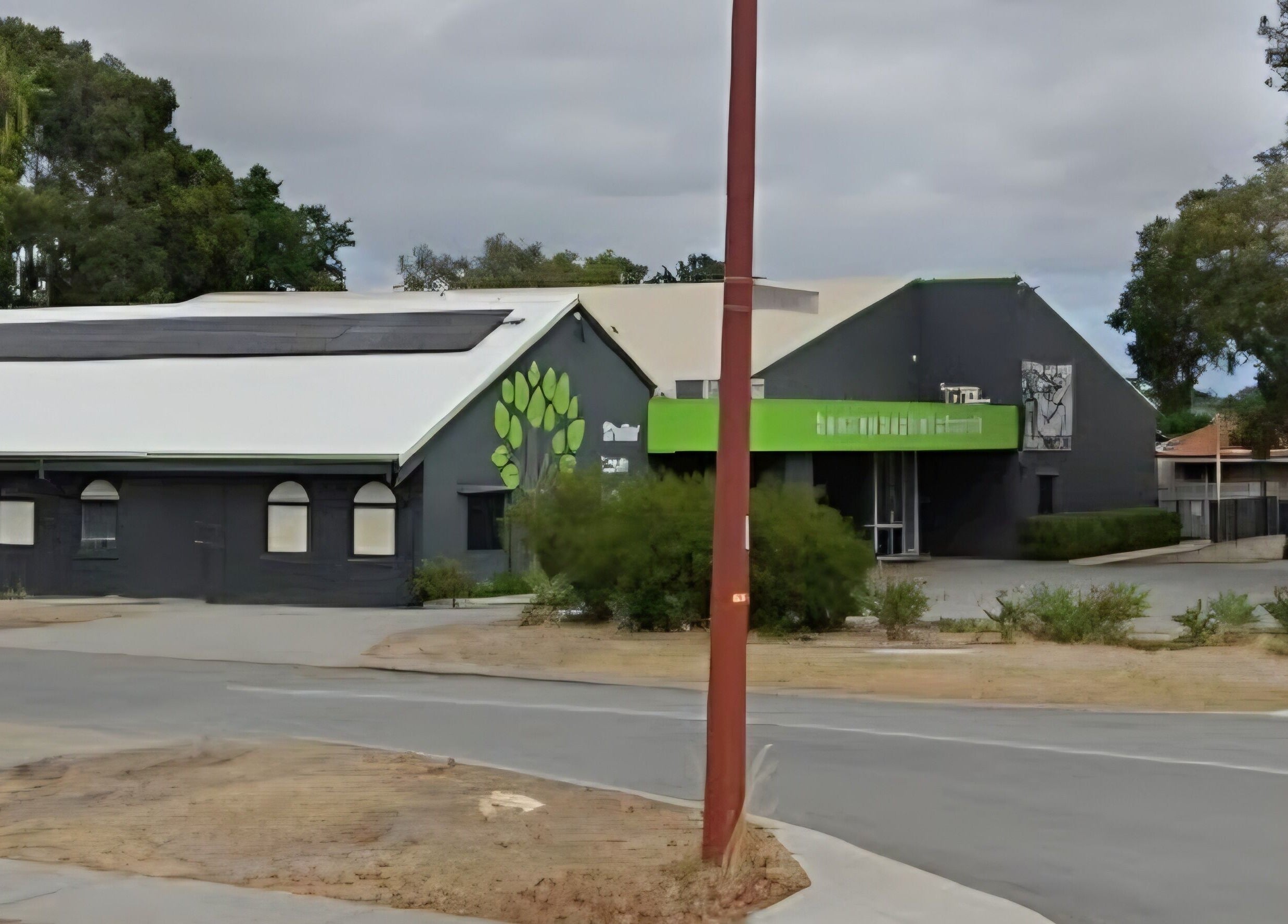 Exterior of Doin Just Fine - Fine Line Tattoo in Bentley, Western Australia. Modern design with green accents.