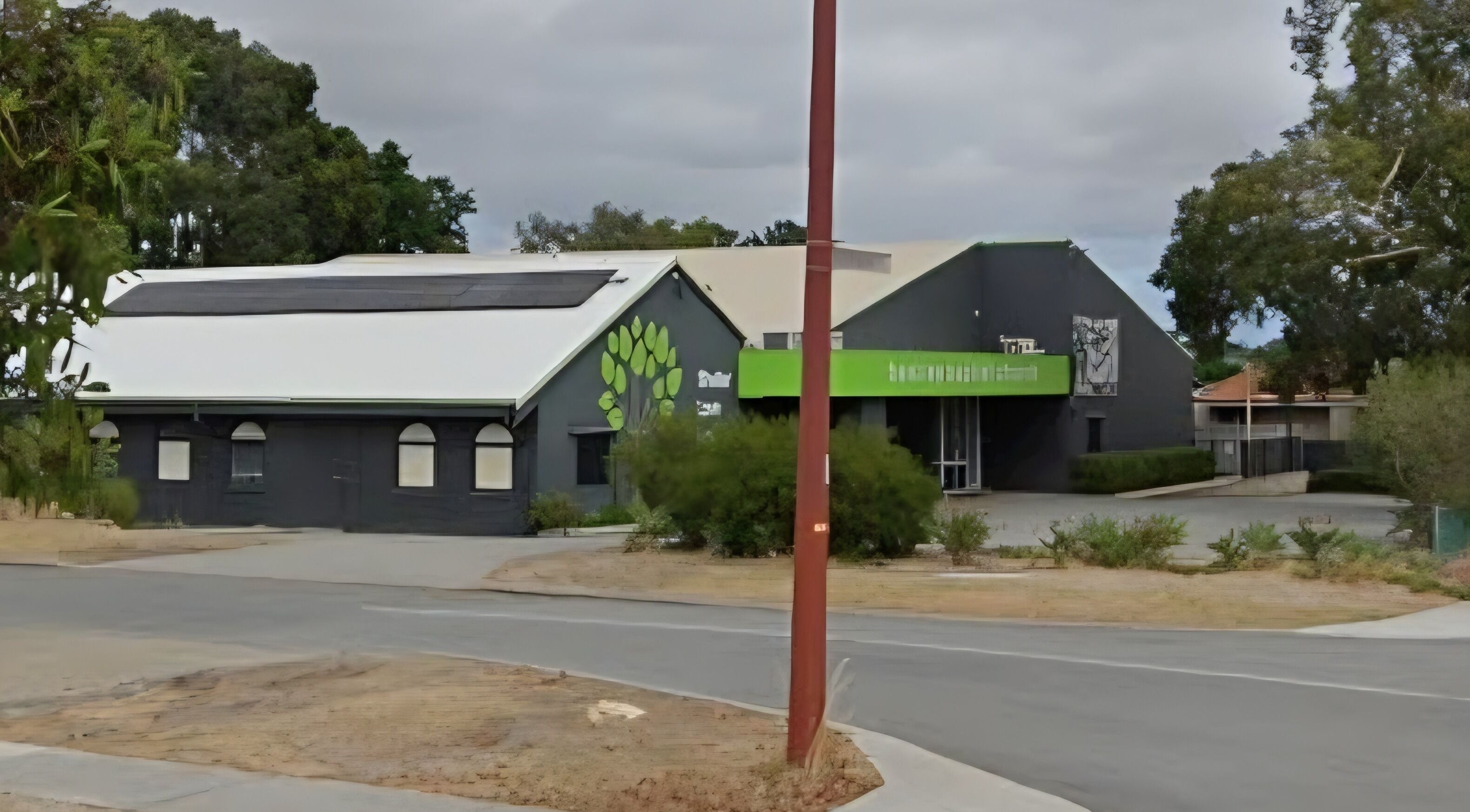Exterior of Doin Just Fine - Fine Line Tattoo in Bentley, Western Australia. Modern design with green accents.
