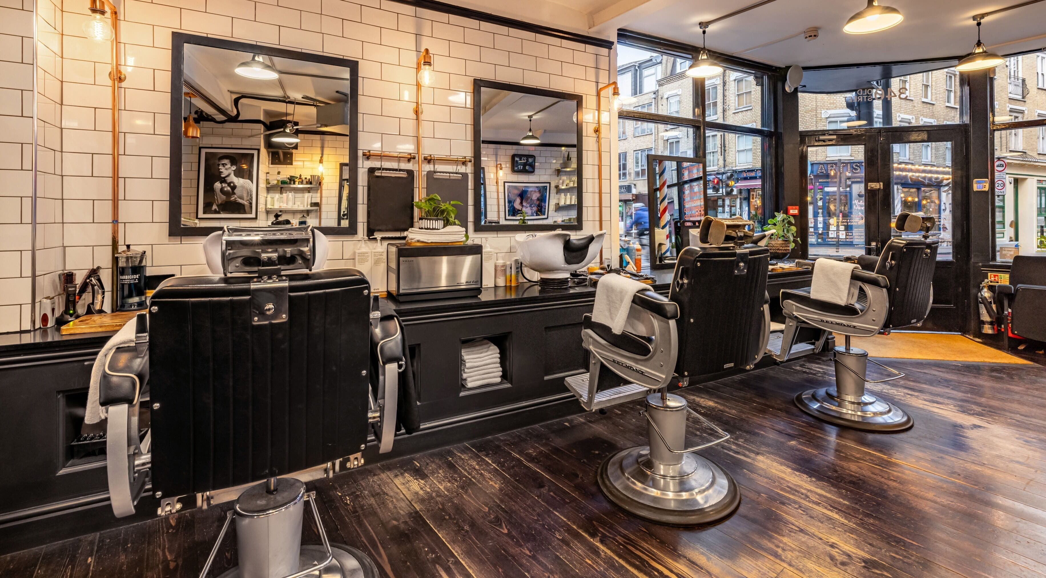Stylish barber chairs at Huckle Old Street in London, England, GB, showcasing a modern grooming space.