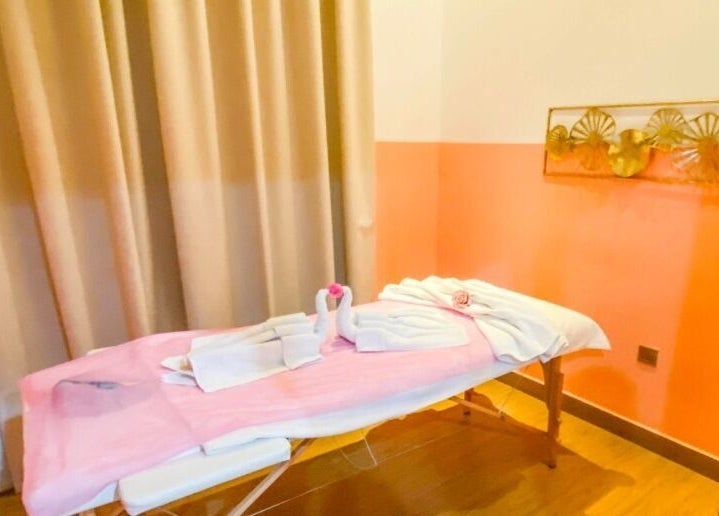 Massage room with cozy pink decor at Am Grace & Glam Beauty Center Arjan Dubai, Dubai, AE.