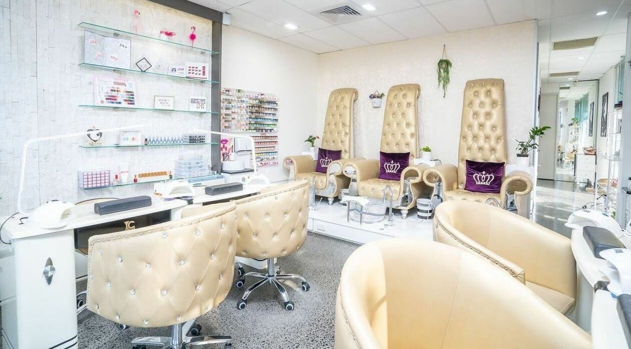 Elegant nail salon interior at Delax Beauty in Melbourne, Victoria, AU featuring plush seating and manicure tables.