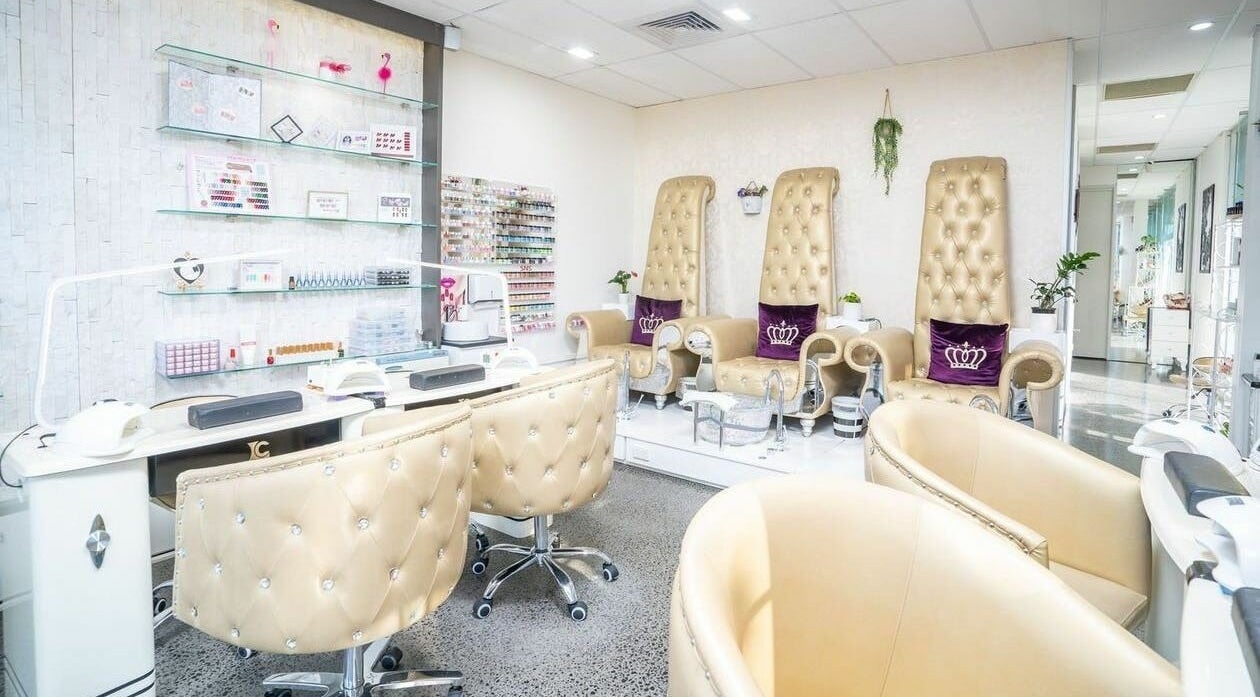 Elegant nail salon interior at Delax Beauty in Melbourne, Victoria, AU featuring plush seating and manicure tables.
