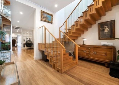 Stylish wooden staircase at MRB Massage Therapy in Melbourne, Victoria, AU creates a welcoming ambiance.