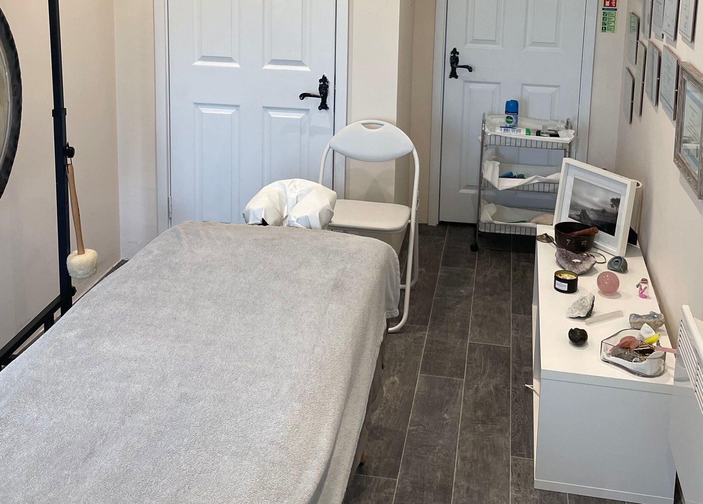 Calming therapy room at Farnborough ART of Healing, featuring a massage table and gong. Farnborough, England, GB.