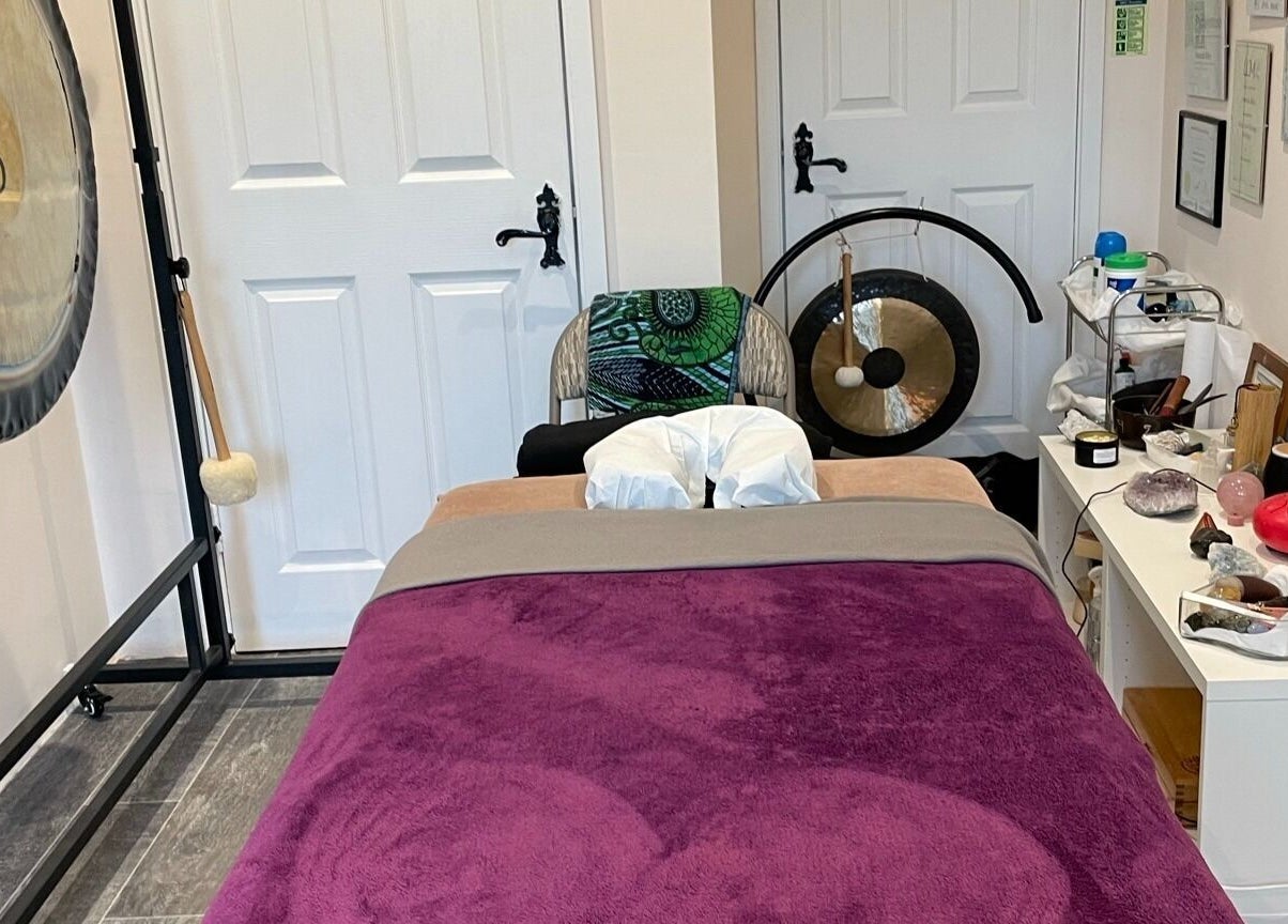Relaxing therapy room at Farnborough ART of Healing, Farnborough, England, GB, featuring massage table and gongs.