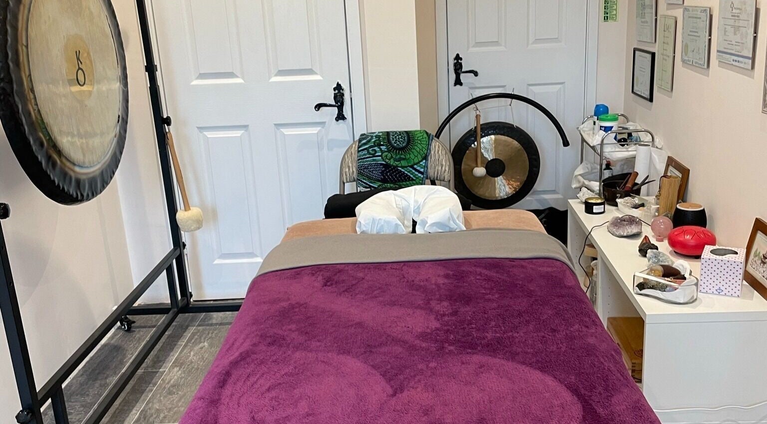 Relaxing therapy room at Farnborough ART of Healing, Farnborough, England, GB, featuring massage table and gongs.