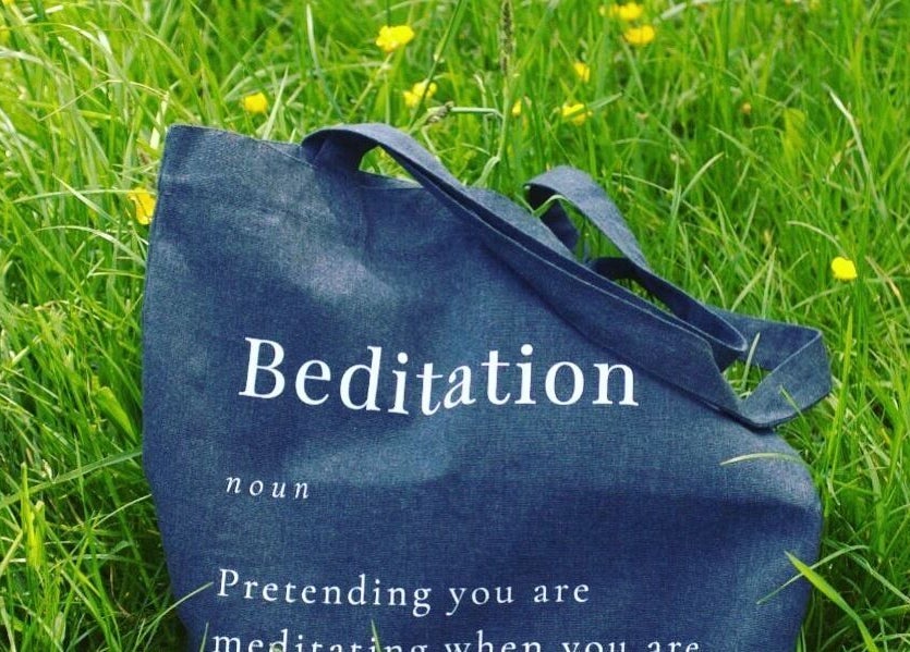 Stylish tote bag in green grass at Farnborough ART of Healing, Farnborough, England, GB.