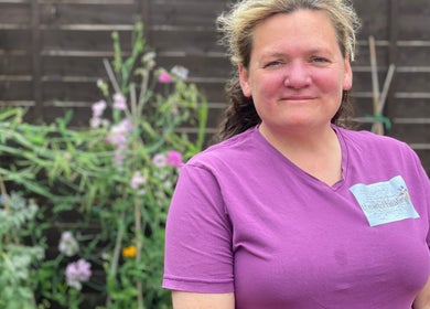 Person in purple shirt at Farnborough ART of Healing garden, Farnborough, England, GB.