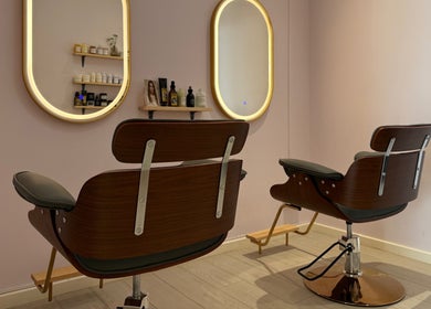 Stylish salon chairs at La Maison Beauté by K, Moka, Moka District, MU. Elegant mirrors and product display in view.