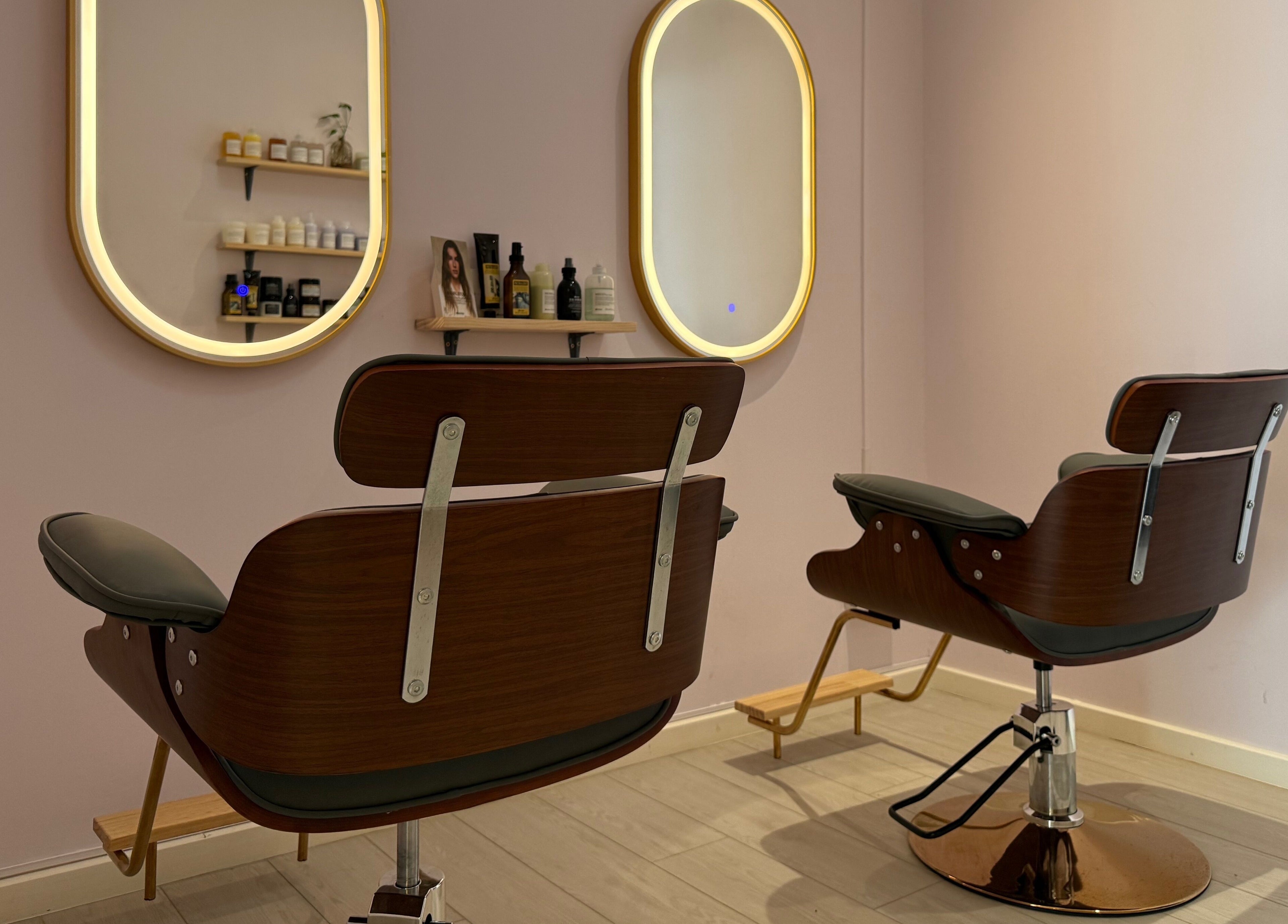 Stylish salon chairs at La Maison Beauté by K, Moka, Moka District, MU. Elegant mirrors and product display in view.