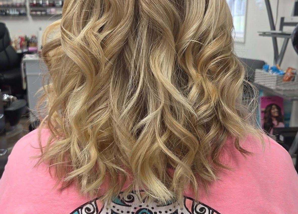 Stylish wavy blonde hairstyle at Erica's Salon & Spa in Monterey, Tennessee, US, showcasing expert hair styling.