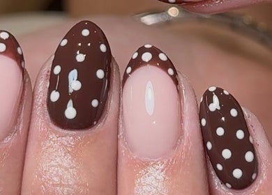 Elegant polka dot manicure by Taylor Minshall in Shafton, England, GB.