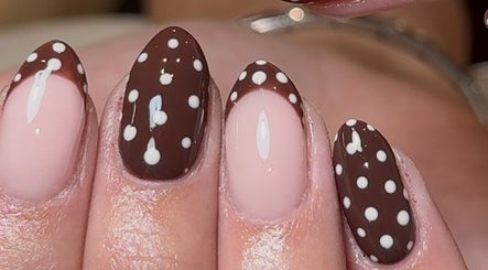Elegant polka dot manicure by Taylor Minshall in Shafton, England, GB.