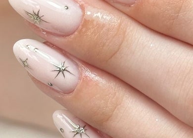 Elegant starry nail art by Taylor Minshall at Shafton, England, GB, showcasing intricate designs and soft hues.