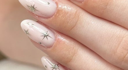 Elegant starry nail art by Taylor Minshall at Shafton, England, GB, showcasing intricate designs and soft hues.