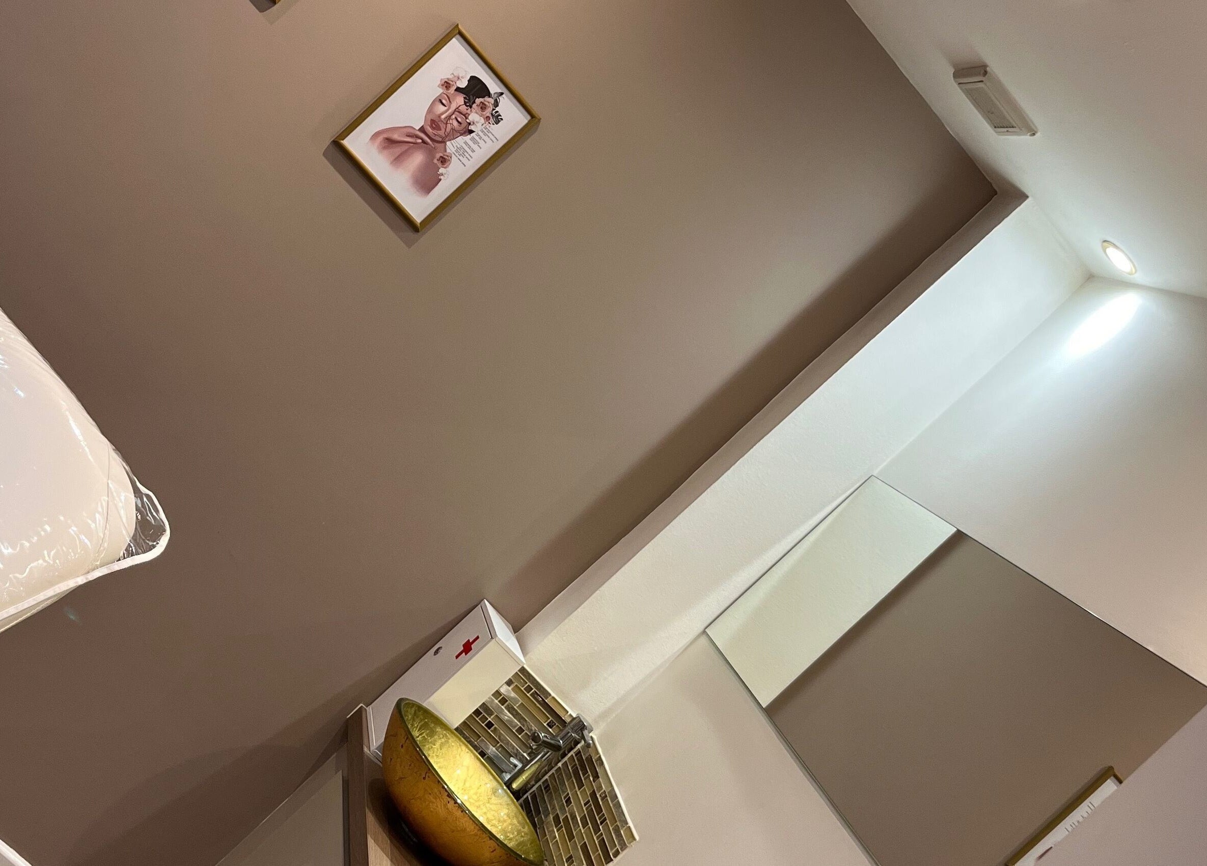 Interior of Adriennes Aesthetics Ltd, Clarkston, Scotland. Cozy treatment room with elegant decor and soothing ambiance.