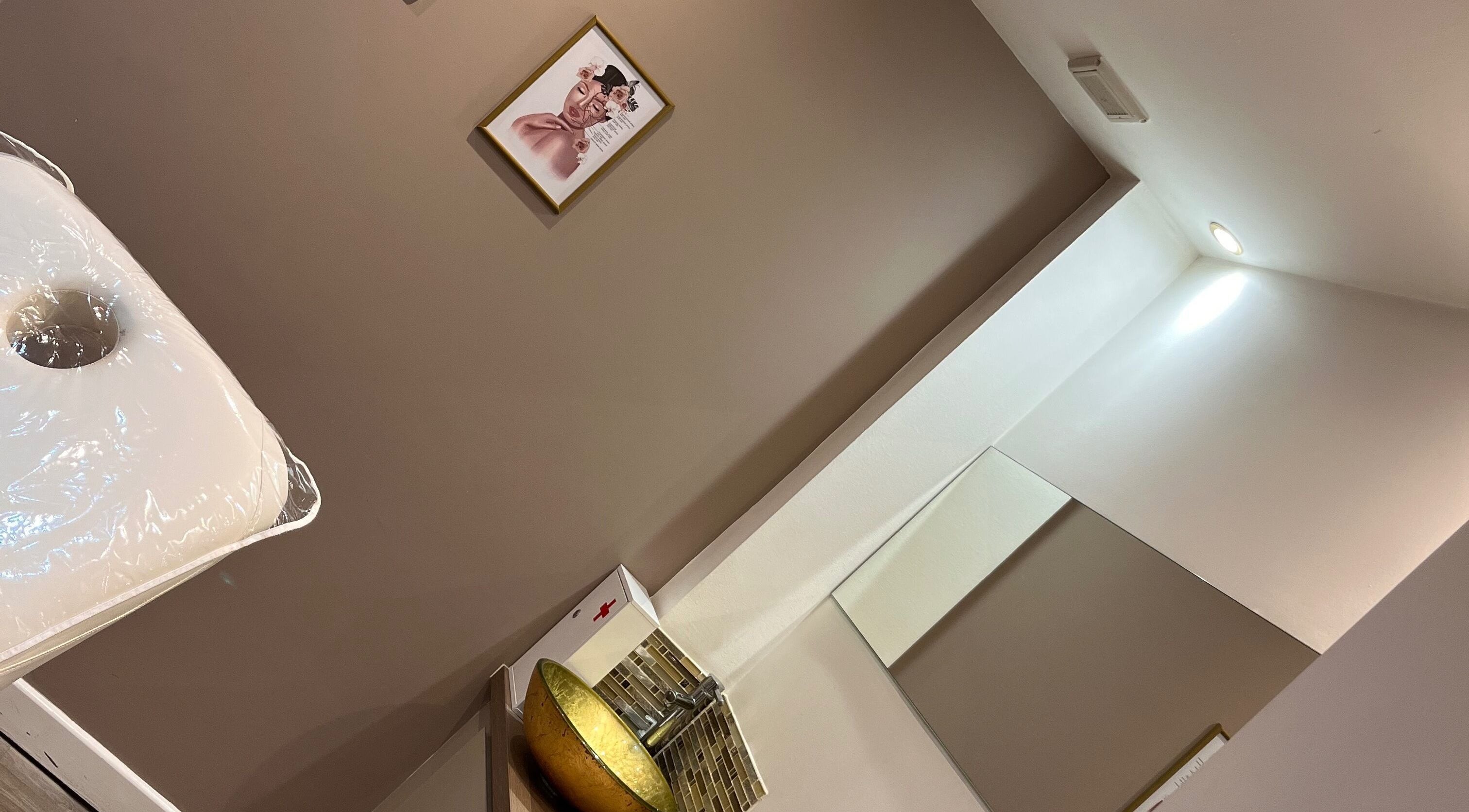 Interior of Adriennes Aesthetics Ltd, Clarkston, Scotland. Cozy treatment room with elegant decor and soothing ambiance.