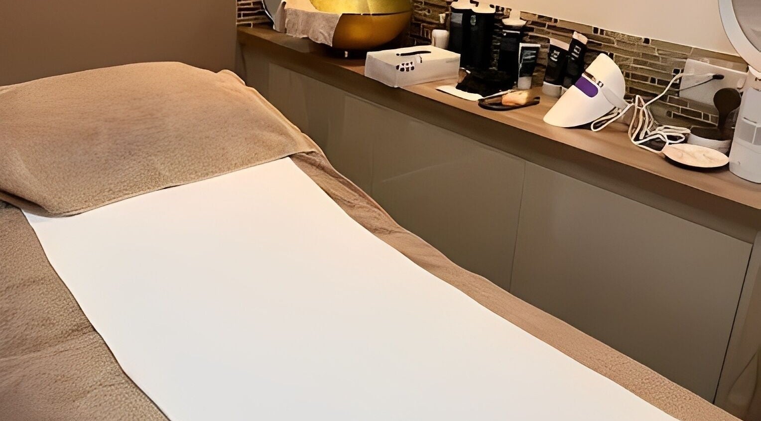 Relaxation treatment room at Adriennes Aesthetics Ltd, Clarkston, Scotland, GB featuring a cozy massage table.