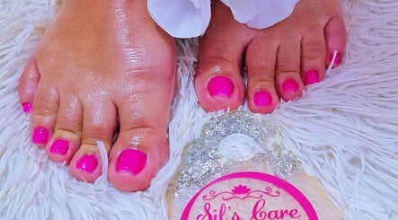 Bright pink toenails freshly done at Sils Care For You in Kralendijk, Bonaire, BQ on soft white mat.