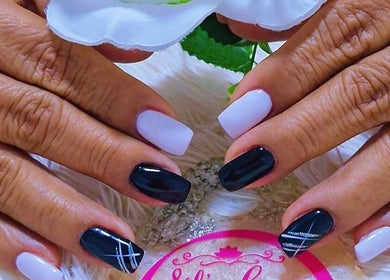 Manicured hands with black and white nails at Sils Care For You, Kralendijk, Bonaire, BQ.