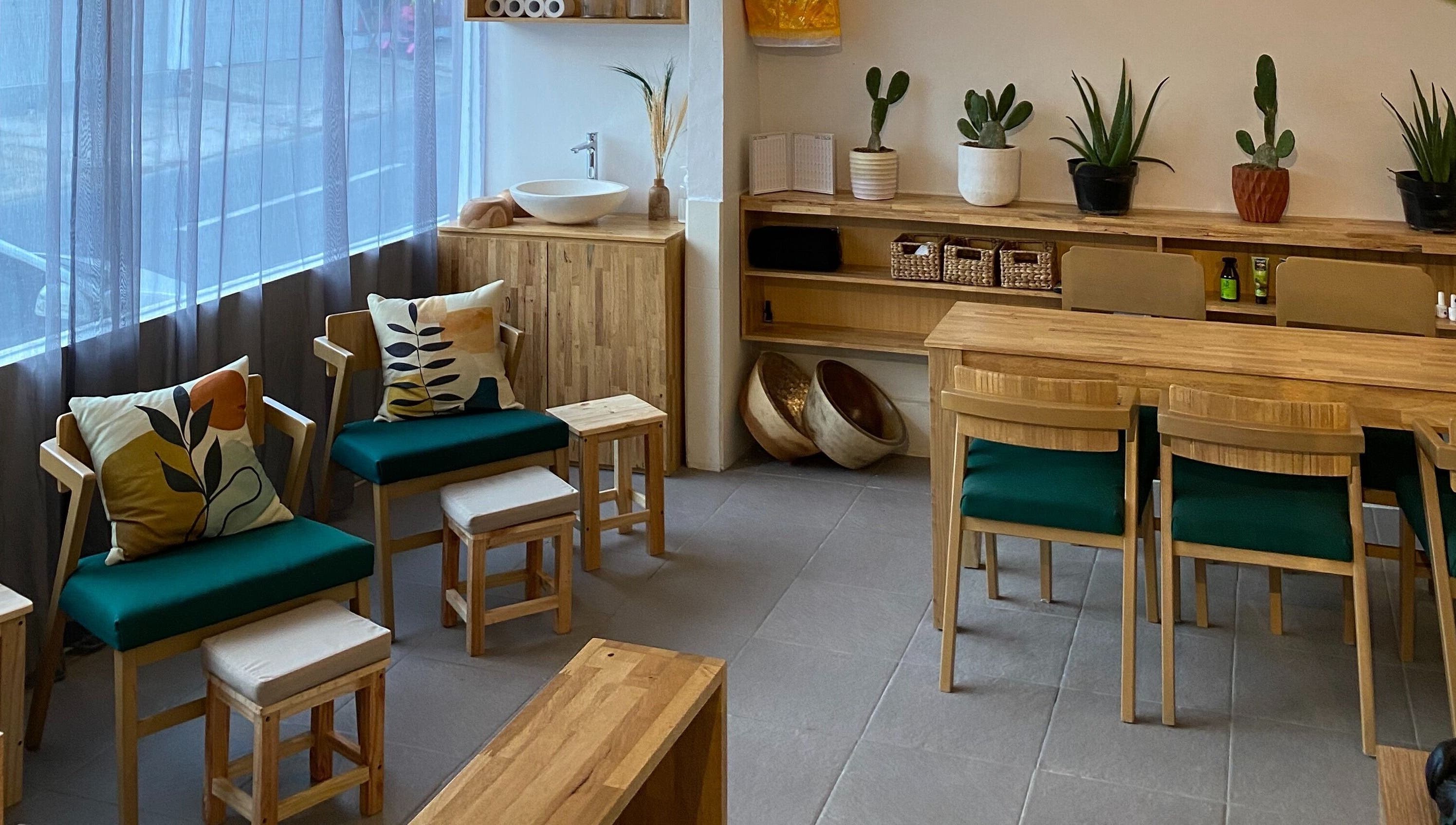 Cozy seating area with green cushioned chairs at Lush Bali Beauty Salon, Bali, Bali, ID.