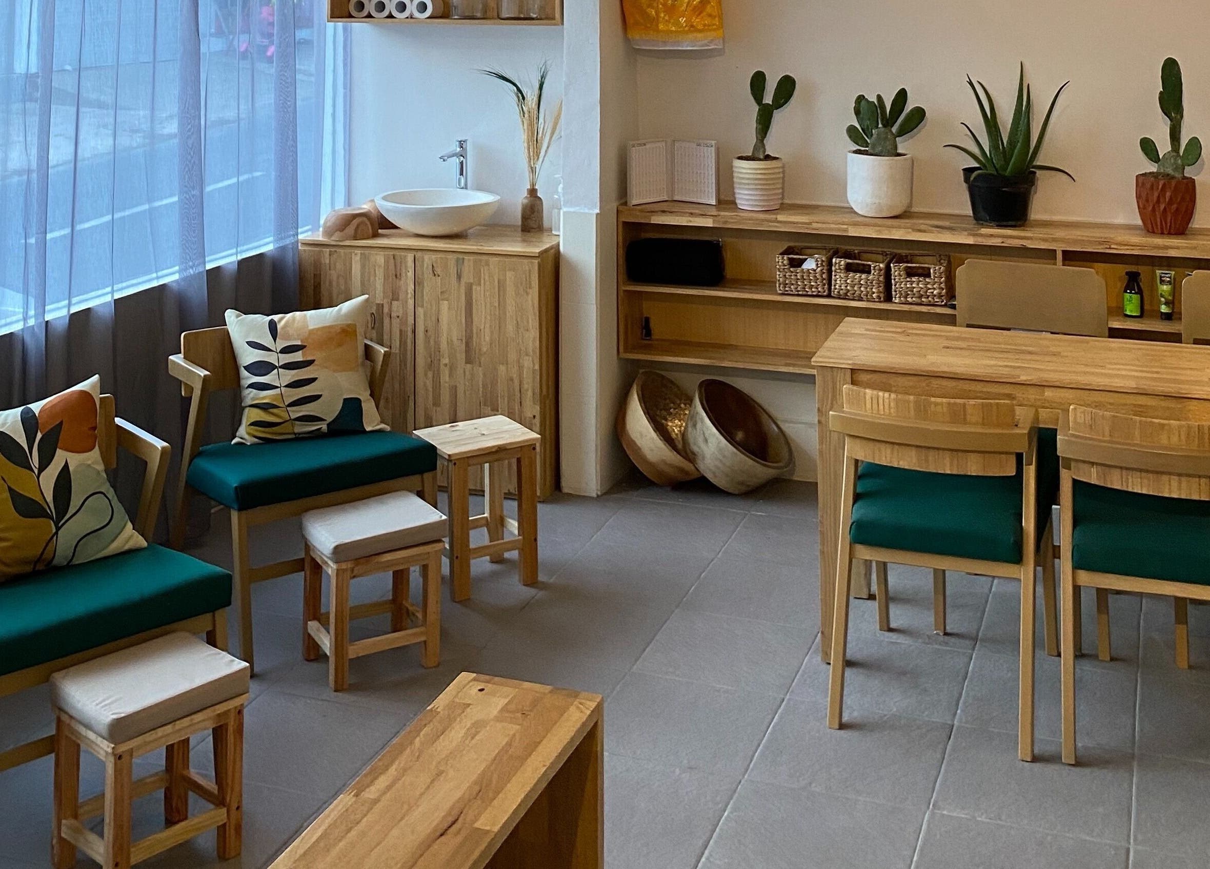 Cozy seating area with green cushioned chairs at Lush Bali Beauty Salon, Bali, Bali, ID.