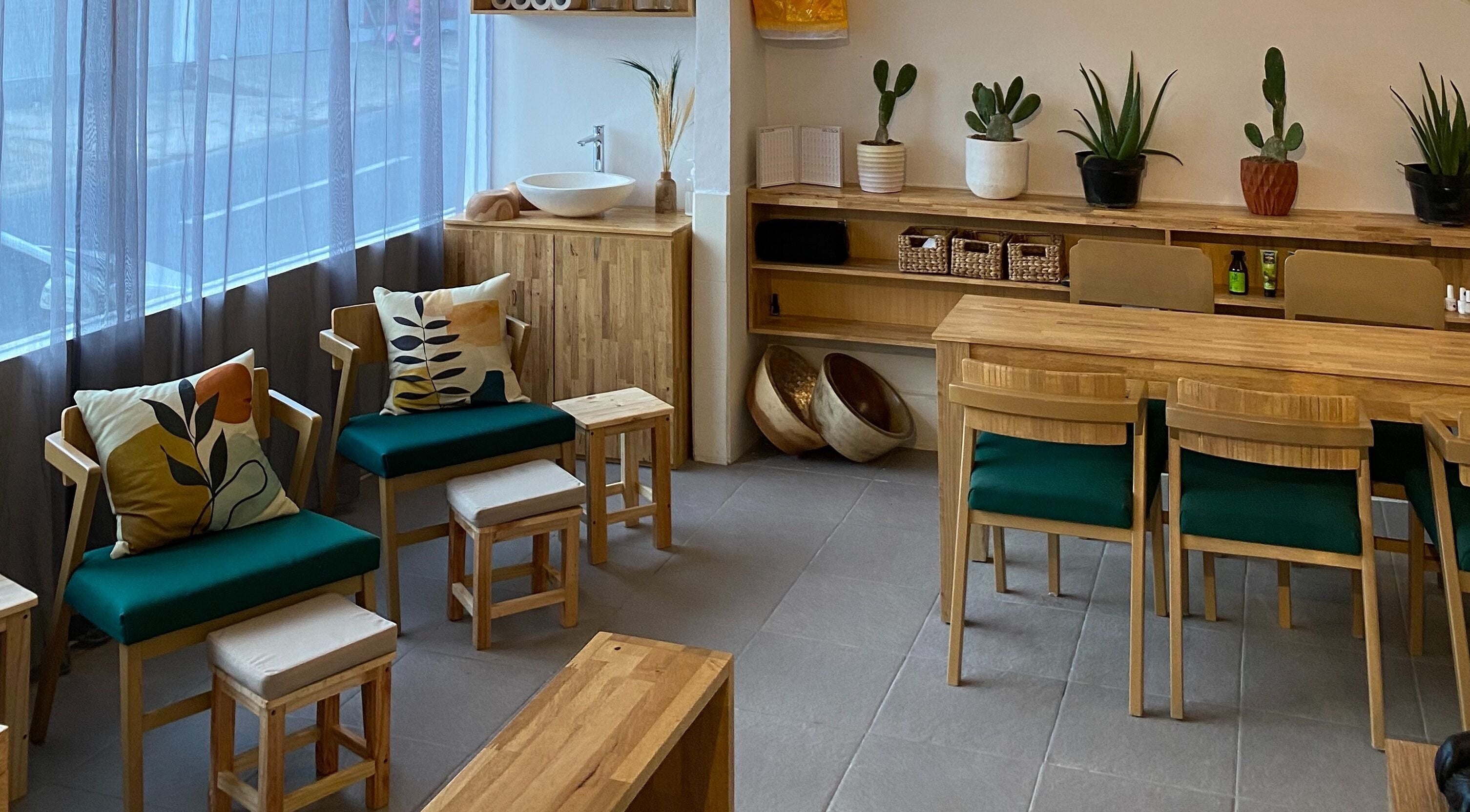 Cozy seating area with green cushioned chairs at Lush Bali Beauty Salon, Bali, Bali, ID.