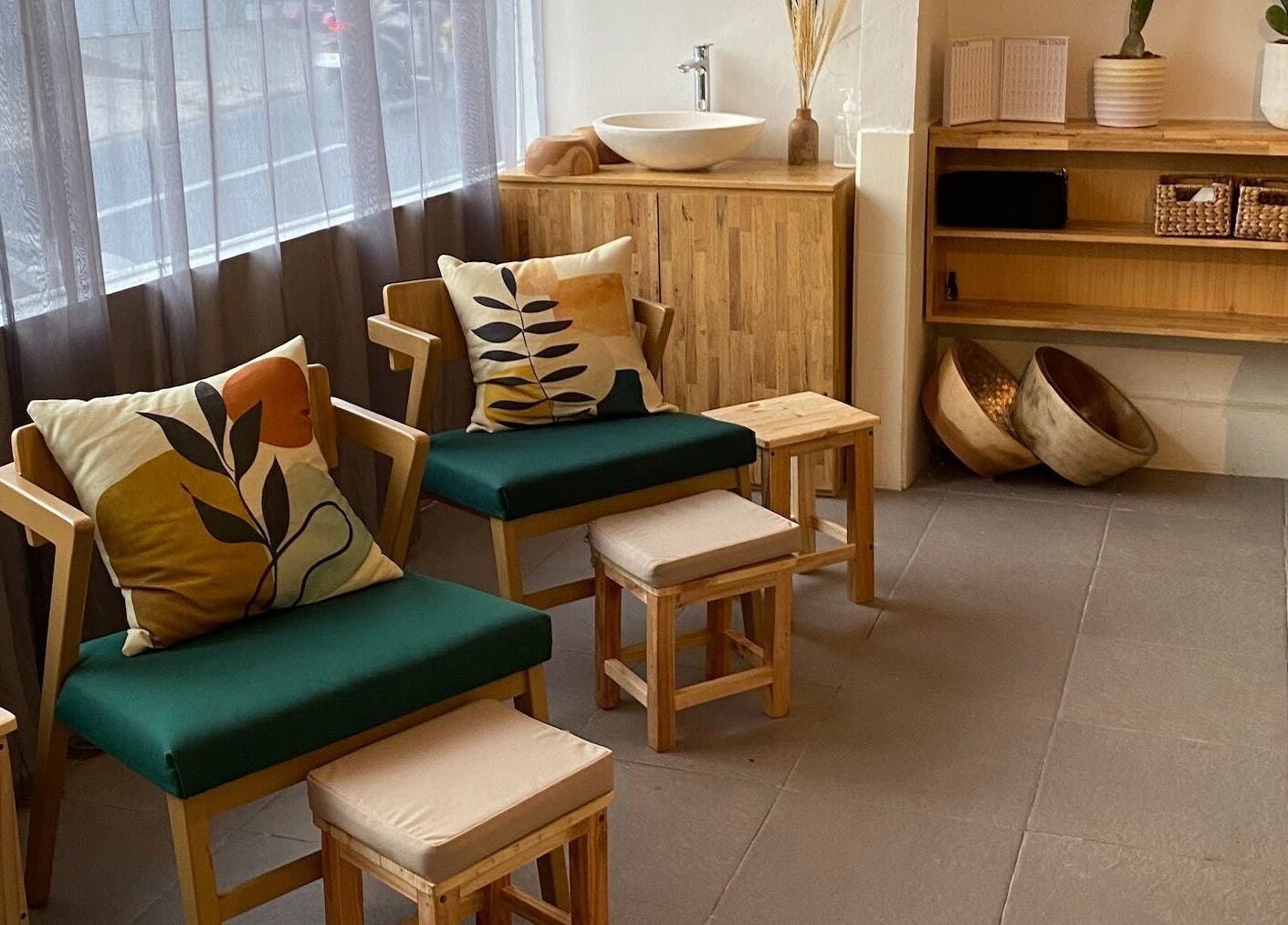 Cozy seating area at Lush Bali Beauty Salon, Bali, ID, featuring wooden chairs and stylish cushions.