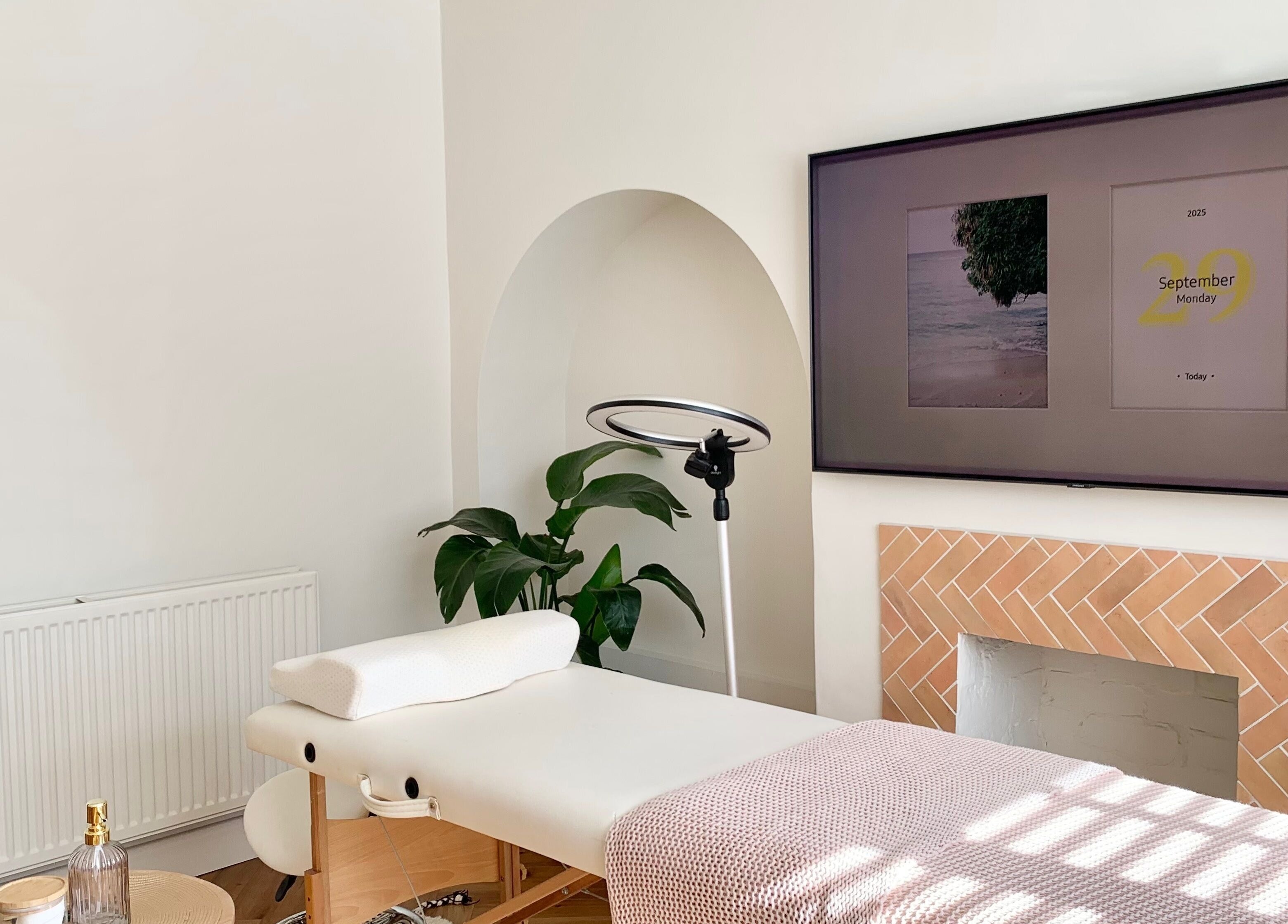 Relaxing treatment room at Lashqueen York, York, England, GB featuring a massage table and cozy decor.