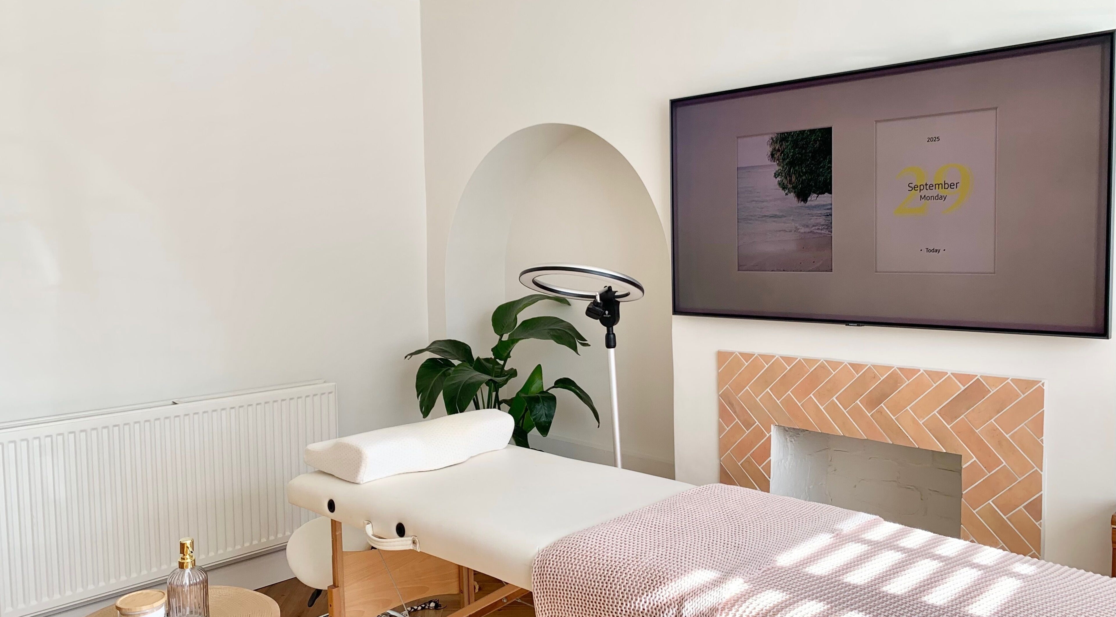 Relaxing treatment room at Lashqueen York, York, England, GB featuring a massage table and cozy decor.