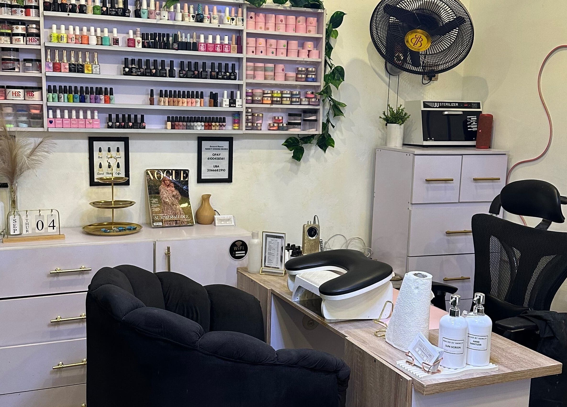 Chic nail salon setup at Nailed by Nanciy, Port Harcourt, Rivers, NG. Stylish shelves with vibrant nail polishes.