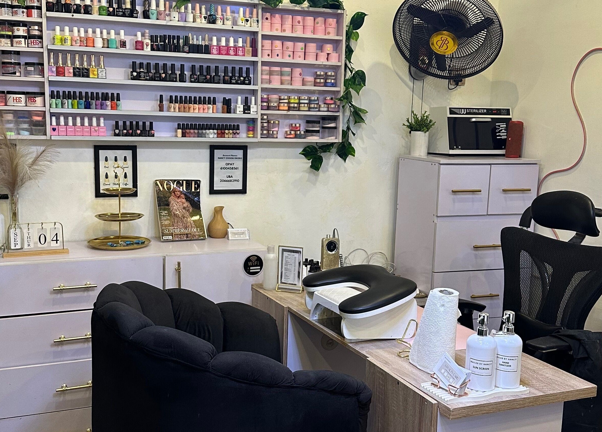 Chic nail salon setup at Nailed by Nanciy, Port Harcourt, Rivers, NG. Stylish shelves with vibrant nail polishes.