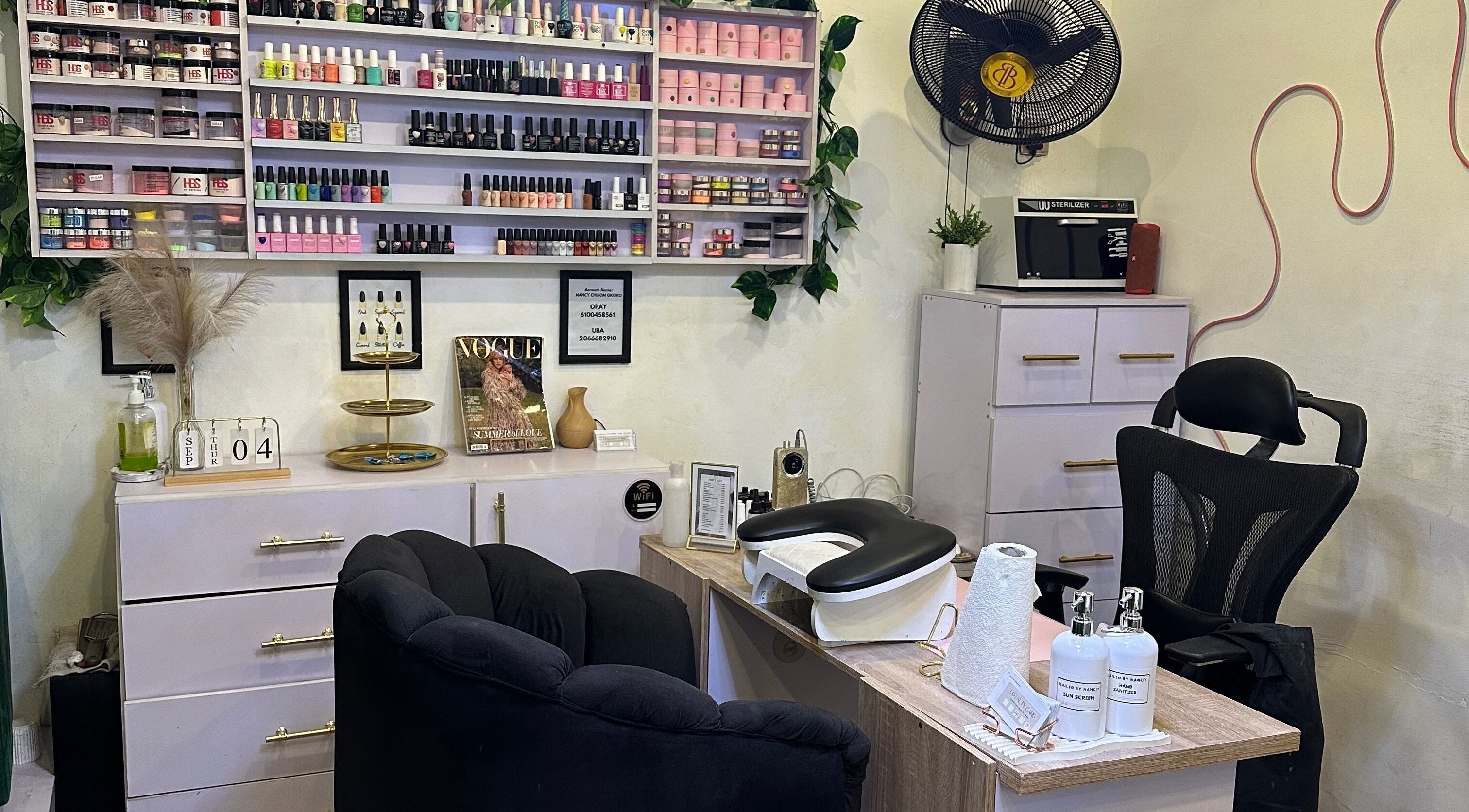 Chic nail salon setup at Nailed by Nanciy, Port Harcourt, Rivers, NG. Stylish shelves with vibrant nail polishes.