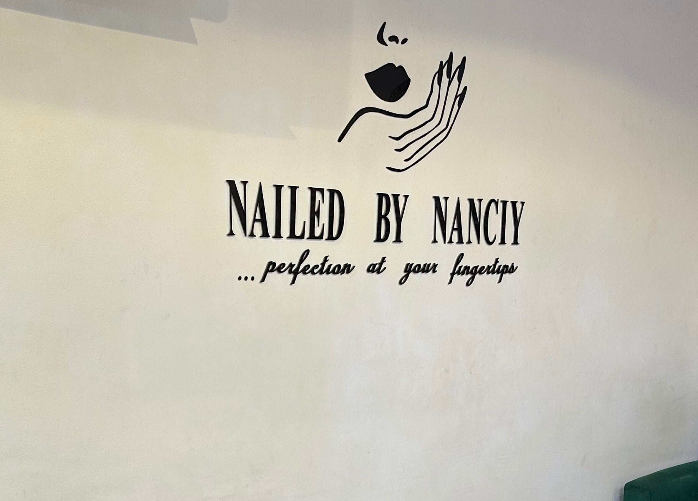 Interior signage of Nailed by Nanciy at Port Harcourt, Rivers, NG with elegant nail art design.
